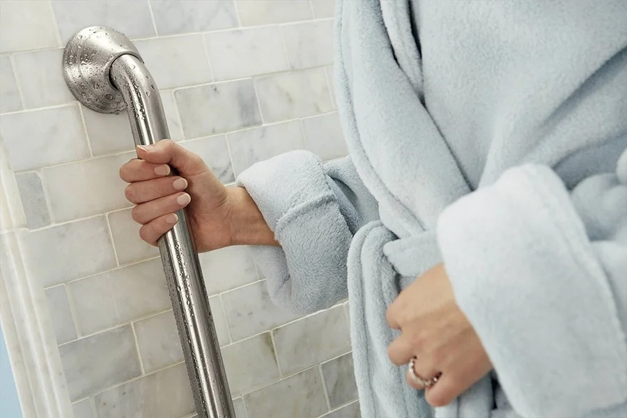 a hand holding on to grab bar