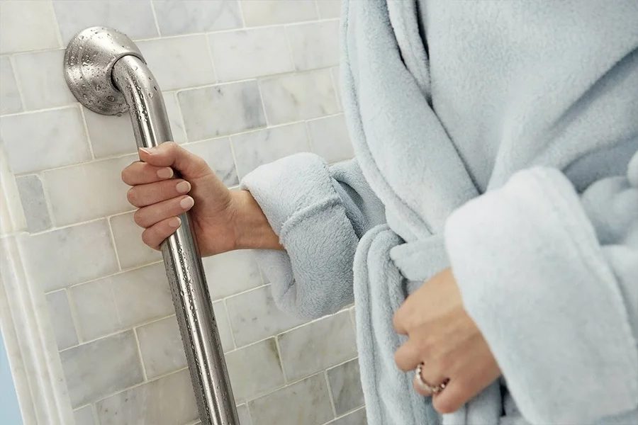 a hand holding on to grab bar