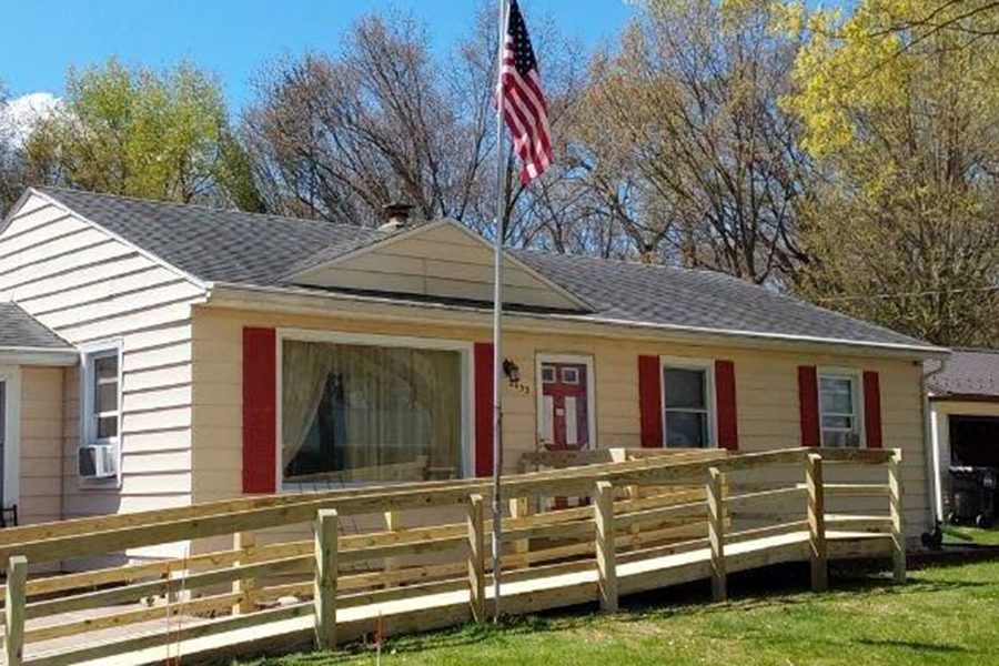 home with ramp and a flag